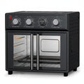 Black toaster oven with food inside on a white background