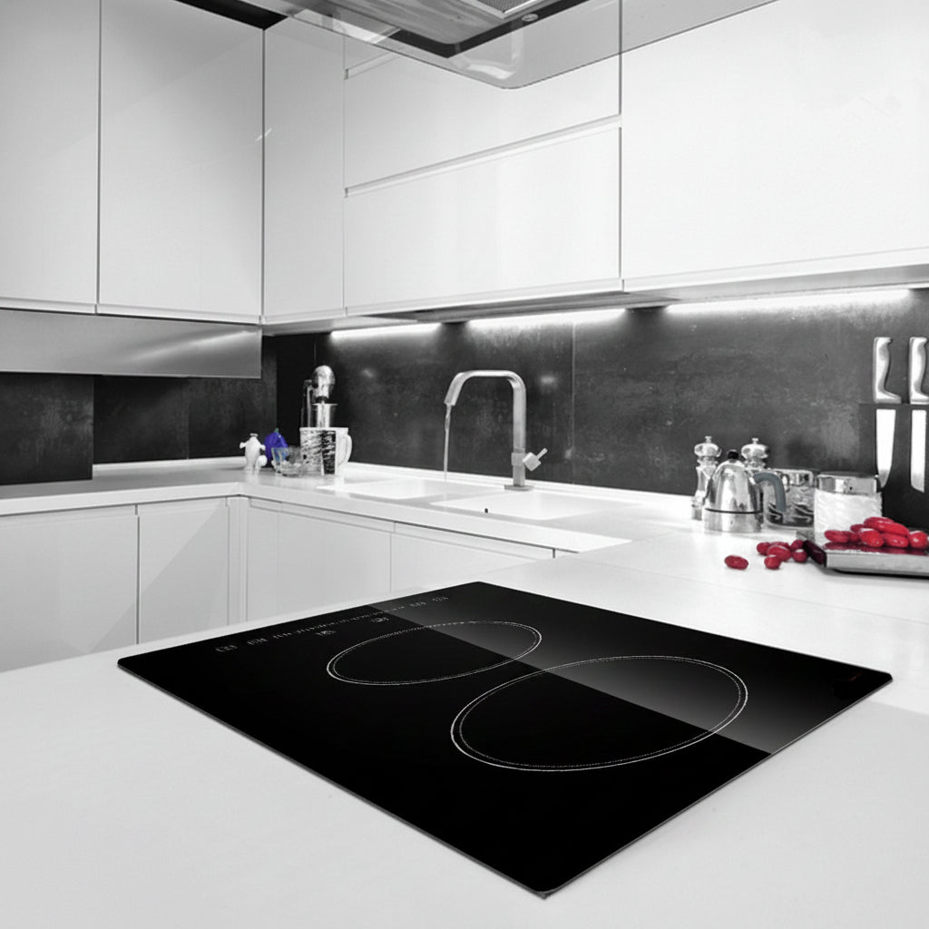 Modern kitchen with a black induction cooktop on a white countertop.